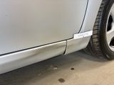 a close up of a car ' s tire on the side of the road