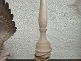 two statues of birds on a table next to each other