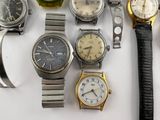 many different types of watches on a white surface