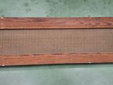 a close up of a wooden shelf with a basket on top of it