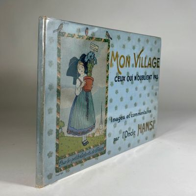 an old book with a picture of a woman in a blue dress