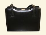 black leather handbag with two handles on a white background