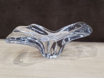 clear glass vase on a wooden table with a brown background