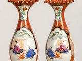 two vases that are sitting on a table