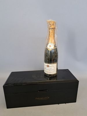 une bouteille de champagne posée sur une boîte noire