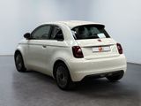the small white car is parked in the large white room