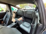the interior of a car with black leather seats and a brown seat belt