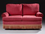 an image of a red couch with fringes on it