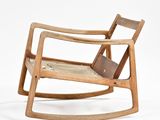 a wooden rocking chair with a book on it