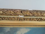 a picture of a gold frame with a painting on it