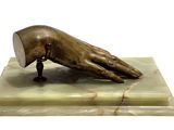 statue of a hand holding a book on a marble base