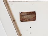 a plaque on the side of a white boat