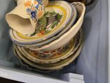 a stack of plates and cups in a blue box