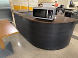 a microwave sitting on top of a counter next to a table