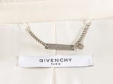 the label on the back of a white dress with a chain on it