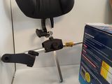 a black chair that is on a tripod next to a box