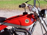 a red motorcycle parked on the side of the road