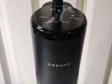 a black and silver coffee maker on a white table