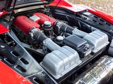 the engine of a red sports car with its hood open