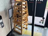 a stack of wooden chairs in the corner of a room