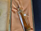 a bottle of perfume in a box on a table