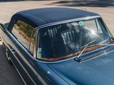 an image of a blue car parked in a parking lot