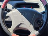 a steering wheel of a car with a red and white stripe