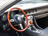 a steering wheel and dashboard of a sports car