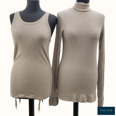 two women ' s sweaters on a mannequin stand with a white background