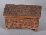 a small wooden box with a design on it