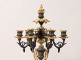 a black and gold candelab with a bunch of candles on it