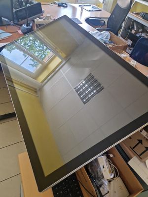 a computer monitor sitting on top of a wooden desk