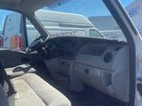 the interior of a white van with the driver ' s seat up