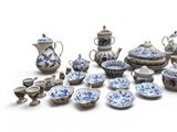 a large collection of blue and white dishes and cups
