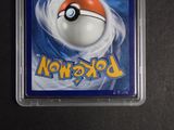 the pokemon card is in a plastic case on a table