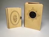 pair of antique book covers with a picture of a woman and a man