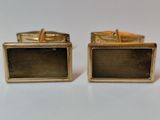 two pairs of gold cufflinks with black glass on them