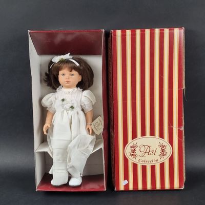 an image of a doll in a box with a red and white striped box