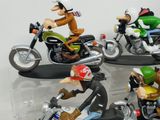 three figurines of people riding motorcycles on display