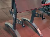 a bench in the middle of a gym with a row of machines