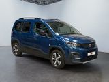 the blue van is parked in a large room with a black floor