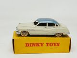 a toy car on top of a box on a white surface