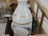 a white vase in a wooden crate with other items in it