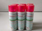 four spray cans of pink paint sitting on top of a white counter
