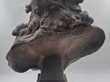 sculpture of a lion head on a wooden base on a white background