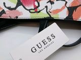a purse with a tag on it sitting on a table