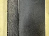 un livre noir posé sur une table blanche