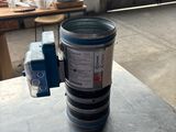 a metal container with a blue lid sitting on top of a table