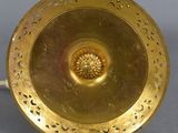 a gold plate with a flower in the middle of it