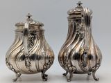 a pair of silverplated sugar and pepper shakers